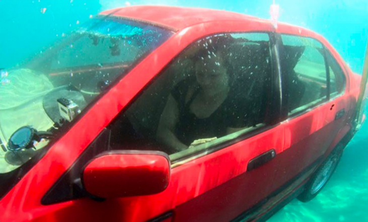 Image of a woman in a car underwater